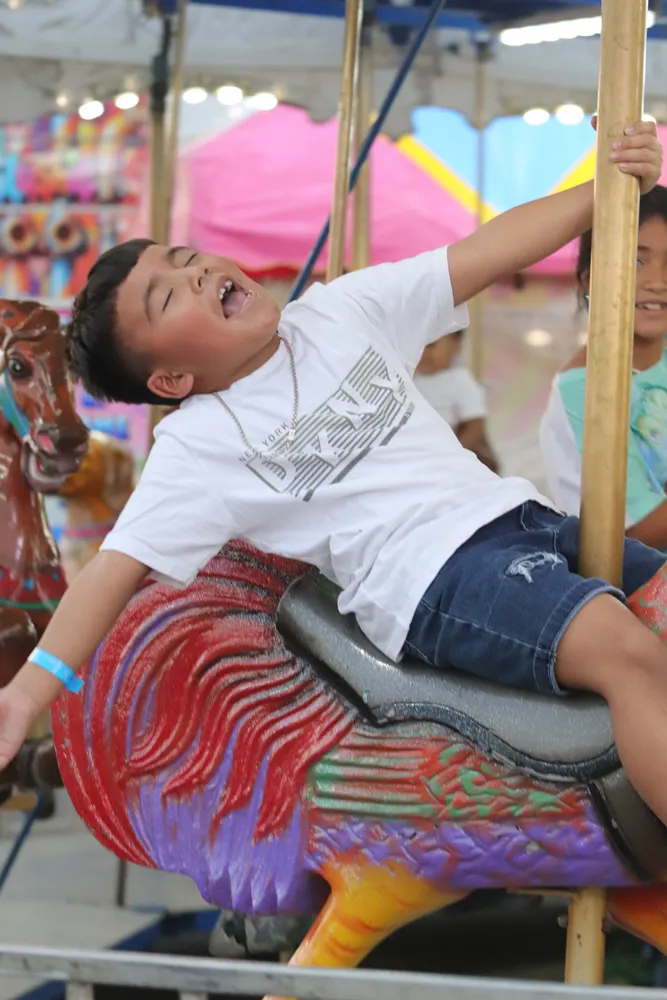 Young children on a small carnival ride