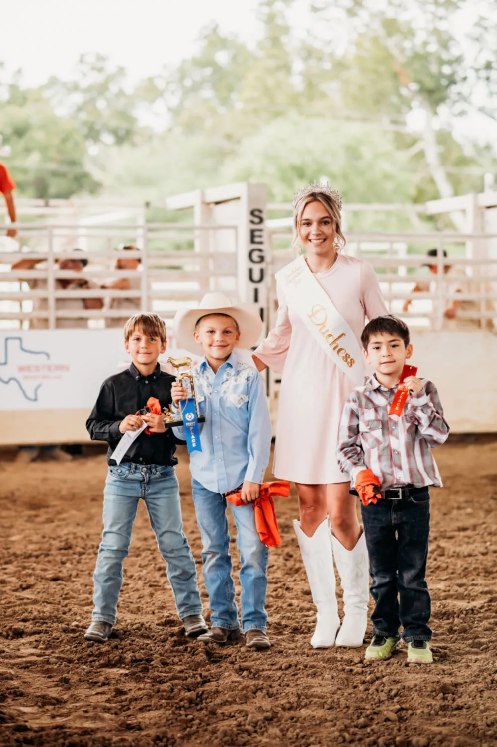 Child riding a sheep in mutton bustin’
