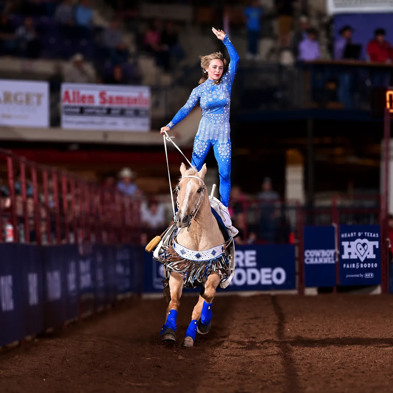 Bethany performing a trick riding stunt on horseback